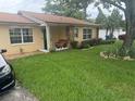 Well maintained front yard with flourishing landscaping leading up to the charming front porch at 808 Ware Ne Ave, Winter Haven, FL 33881