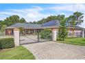 View of the home and property showing fence and gated entry at 9950 W Lake Marion Rd, Haines City, FL 33844