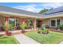 Inviting covered front porch with decorative plants and flowers creating a welcoming entrance to the home at 9950 W Lake Marion Rd, Haines City, FL 33844