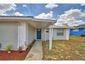 Charming single-story home with a metal roof, freshly painted exterior and landscaped front yard at 101 Babson Heights Dr, Babson Park, FL 33827