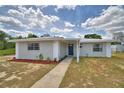 Charming single-story home with a metal roof, freshly painted exterior and landscaped front yard at 101 Babson Heights Dr, Babson Park, FL 33827
