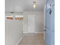 Inviting foyer with tiled flooring, neutral walls, and access to the rest of the house at 1010 Biltmore Nw Dr, Winter Haven, FL 33881