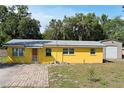 Lovely single-Gathering home with colorful exterior, well-manicured lawn, and private driveway at 1163 Lake Dr, Lake Wales, FL 33859