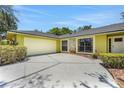 Attached two-car garage featuring a modern door and concrete driveway providing ample parking space at 1226 Lake Loop, Winter Haven, FL 33880