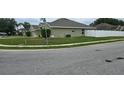 Street view of a well-manicured lawn surrounding a single-story home at 1400 Eagle Crest Blvd, Winter Haven, FL 33881