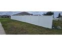 View of a pristine white fence providing privacy to the backyard at 1400 Eagle Crest Blvd, Winter Haven, FL 33881