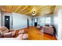 This living room features hardwood floors, a wooden ceiling, a ceiling fan, and stylish furnishings at 1515 W Lake Cannon Nw Dr, Winter Haven, FL 33881