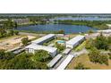 Gorgeous aerial view of the community and nearby lake with building exterior and parking visible at 1700 6Th Nw St # C26, Winter Haven, FL 33881