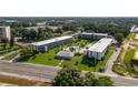 Lovely aerial view of the property showcasing the community pool, lawn and building exterior at 1700 6Th Nw St # C26, Winter Haven, FL 33881