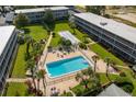 Stunning aerial view of the community pool, picnic areas, and building exterior at 1700 6Th Nw St # C26, Winter Haven, FL 33881
