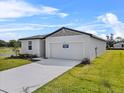 Well-maintained one-story home with a two-car garage and lush green lawn at 1752 Forest Run Ln, Auburndale, FL 33823