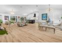 Bright, open-concept living room with hardwood floors, modern lighting, and ample seating at 1850 S Lake Reedy Blvd, Frostproof, FL 33843