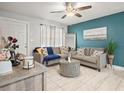 Cozy living room featuring stylish decor, comfortable seating, and a ceiling fan at 2100 Magnolia Ave, Haines City, FL 33844