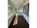 Bright sunroom with floor to ceiling windows and brown carpet at 217 Nw 4Th Ave, Mulberry, FL 33860