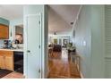 Hallway view with kitchen and living room access and hardwood flooring at 2180 San Marcos Se Cir # 401, Winter Haven, FL 33880