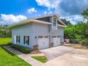 Modern two-story home featuring a two-car garage, stone accents, and manicured landscaping at 250 Brigham Nw Rd, Winter Haven, FL 33881