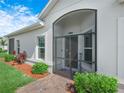 Screened front entry way with brick pavers and lovely landscaping at 2824 Attwater Loop, Winter Haven, FL 33884