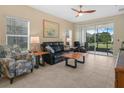 Comfortable living room with tile flooring and sliding glass doors to a lanai at 2824 Attwater Loop, Winter Haven, FL 33884