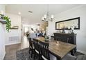 Open-concept dining room with stylish furniture and decor, flowing into the kitchen and living areas at 2980 Dayton Dr, Winter Haven, FL 33884