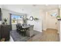 Well-lit dining room features a wooden table, stylish decor, and a large window with natural light at 2980 Dayton Dr, Winter Haven, FL 33884
