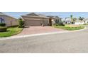 Charming home with a brick driveway, two-car garage, and lush green lawn at 2980 Dayton Dr, Winter Haven, FL 33884