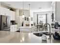 Contemporary kitchen with a kitchen island, stainless steel appliances, and granite countertops with modern lighting at 2980 Dayton Dr, Winter Haven, FL 33884