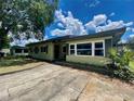 The exterior of this single story home features a concrete driveway and simple landscaping at 3022 Hickory Nw St, Winter Haven, FL 33881