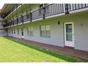 Exterior view of the building, showcasing the balconies, windows, and gray facade at 333 Lake Howard Nw Dr # 103C, Winter Haven, FL 33880
