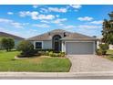 Charming single-story home featuring a well-maintained lawn, a brick-paved driveway and a two-car garage at 3844 Bedford Ave, Winter Haven, FL 33884