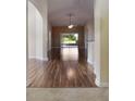 Spacious living room with hardwood floors, ceiling fan, and sliding glass doors leading to the outdoors at 3844 Bedford Ave, Winter Haven, FL 33884