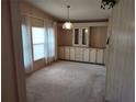 Cozy dining room featuring built-in cabinets, a decorative light fixture, and neutral carpeting at 418 Tivoli Park Dr, Davenport, FL 33897