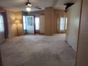 Spacious living room featuring neutral carpet, a ceiling fan, and lots of natural light at 418 Tivoli Park Dr, Davenport, FL 33897
