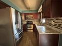 Updated kitchen features granite countertops, tile backsplash and stainless steel appliances at 4211 Sunny Land Dr, Lakeland, FL 33813