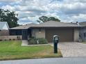 Cozy single-story home boasts a charming exterior, manicured lawn, and convenient attached garage at 426 Gleneagles Ct, Winter Haven, FL 33884