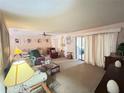 Spacious living room with plush carpet, lots of natural light, and sliding glass door at 426 Gleneagles Ct, Winter Haven, FL 33884