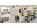 The kitchen has a breakfast bar, white cabinetry, and flows into the living area at 441 San Jose Dr, Winter Haven, FL 33884