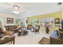 Bright living room featuring a leather sofa, ceiling fan, and natural light at 441 San Jose Dr, Winter Haven, FL 33884