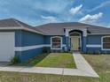 Eye-level shot of the front door with a sidewalk and Spring decor at 541 Hatchwood Dr, Haines City, FL 33844