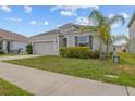 Charming single-story home with a well-manicured lawn and tidy landscaping, with a two-car garage at 622 Taft Dr, Davenport, FL 33837