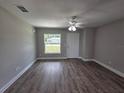 The living room features wood-look floors, freshly painted walls, a ceiling fan, and a bright window view at 628 Se Pine Ave, Fort Meade, FL 33841