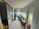 A sun filled Florida room provides additional seating and access to the outdoors at 700 Mirror Nw Ter # 303, Winter Haven, FL 33881
