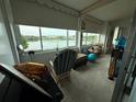 Florida room with lots of natural light and a view of the lake at 700 Mirror Nw Ter # 303, Winter Haven, FL 33881