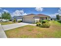Well-maintained home with a two-car garage, concrete driveway, and neatly landscaped front yard at 710 Persian Dr, Haines City, FL 33844