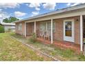 Inviting covered front porch with brick flooring, perfect for relaxing outdoors at 780 Oleander Se Dr, Winter Haven, FL 33880