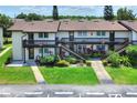 Exterior of the building featuring a manicured lawn and staircase at 900 Avenue Z Se # B2, Winter Haven, FL 33880