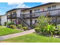 Well-maintained building exterior featuring lush landscaping, an exterior staircase, and multiple units at 900 Avenue Z Se # B2, Winter Haven, FL 33880