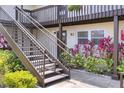 Exterior staircase leading to upper units with a view of the lower-level entrance and lush landscaping at 900 Avenue Z Se # B2, Winter Haven, FL 33880