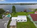 Aerial view of home near a lake featuring a serene escape to calm waterfront living at 900 Lake Jessie Dr, Winter Haven, FL 33881
