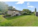 Spacious backyard with green grass and partial fencing, perfect for outdoor activities and relaxation at 105 Leslie Ave, Winter Haven, FL 33880