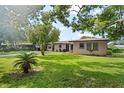 Charming single-story home with well-maintained lawn and mature trees providing shade at 105 Leslie Ave, Winter Haven, FL 33880